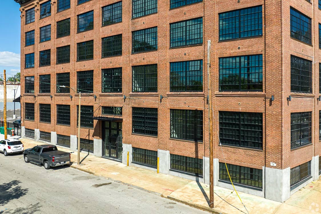 Historic brick building with large black steel replica windows