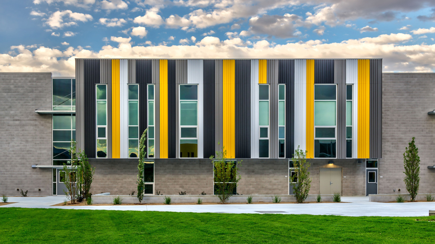 Exterior of a striped yellow and black building, designed to enhance natural light and comfort for Desert Skies Middle School students.