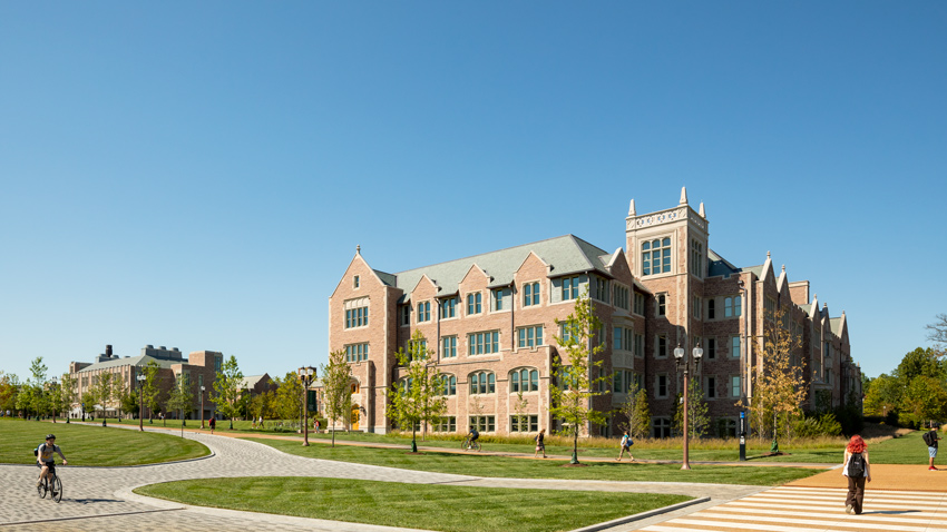 McKelvey Hall, a large brick building with a spacious lawn, showcases Collegiate Gothic architecture and energy-efficient windows.