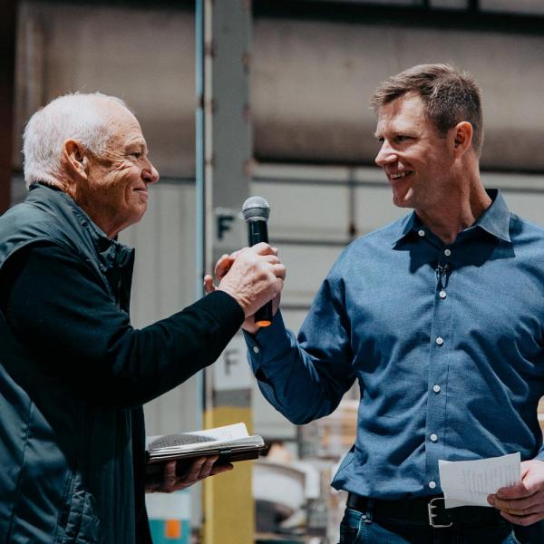 Gantt Miller handing microphone to Woody Miller