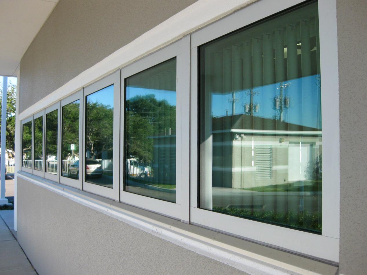 The Public Works Emergency Responders Building (PWERB) is a two-level building that holds a LEED Gold Certification and features Winco tornado-rated windows. Close-up of a building, featuring a tornado resistant window. The setting includes indoor and outdoor elements, highlighting the fixture attached to the wall of a building.