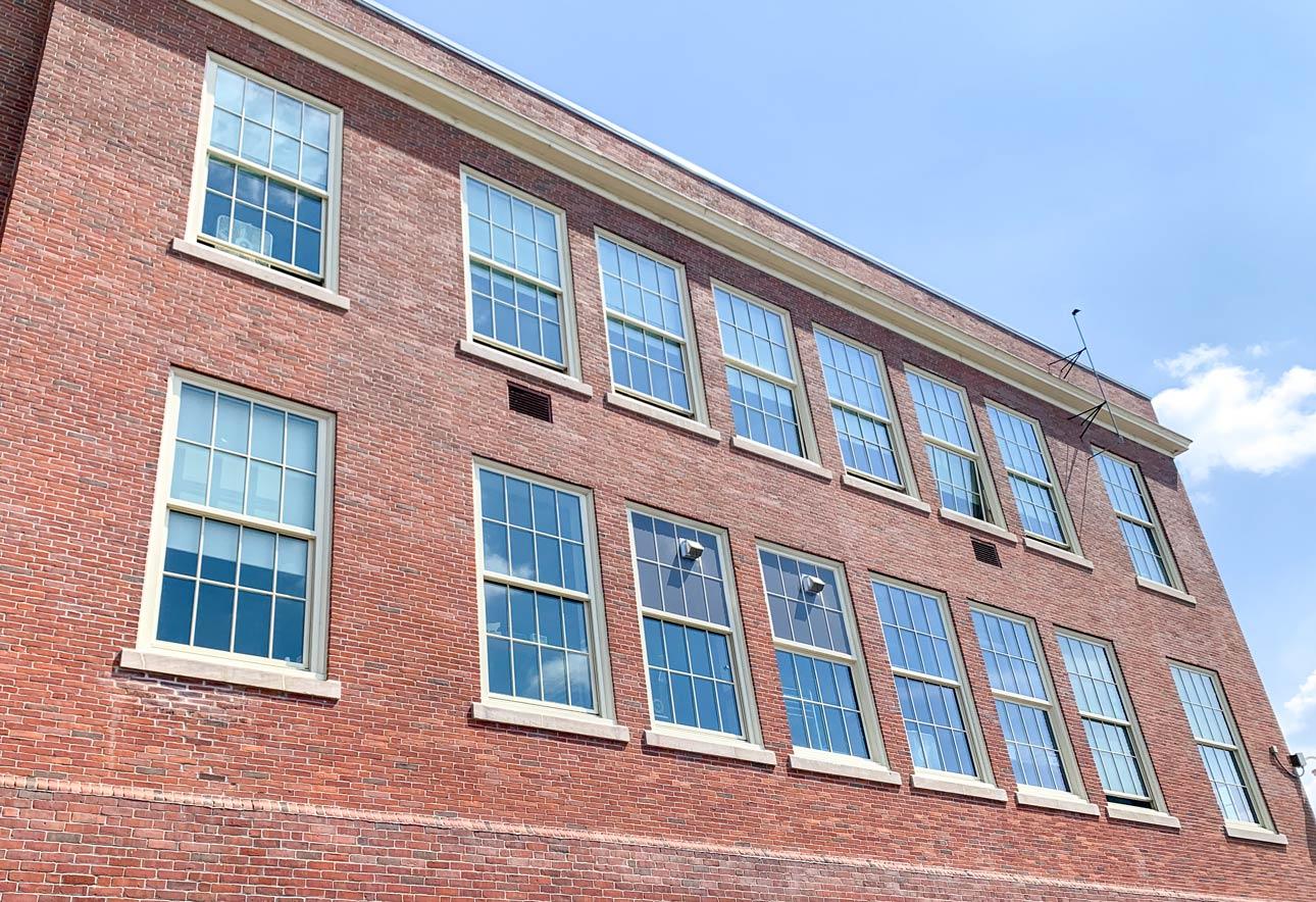 Exterior brick building with historic replica windows