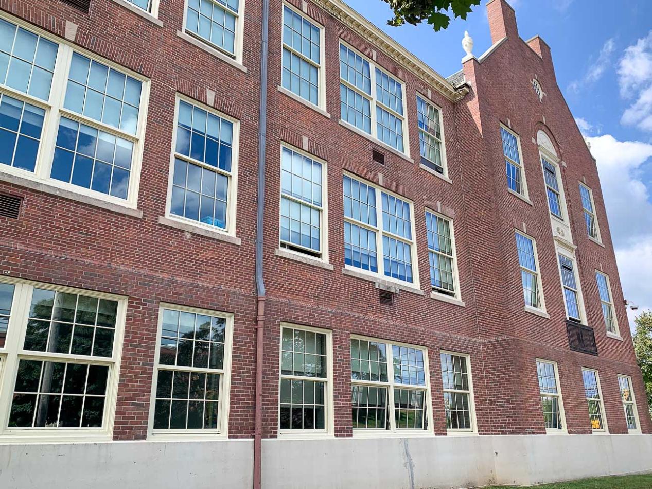 The Pawtucket School Department selected the 4410S Single Hung and 1450S Hung Replica windows for Goff Middle School. Exterior brick building with historic replica windows