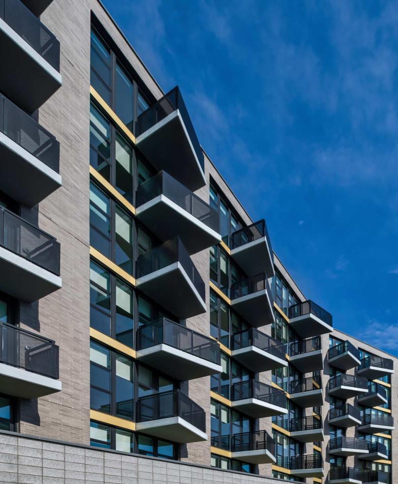 Apartment building in Washington, D.C. featuring balconies with windows and doors.