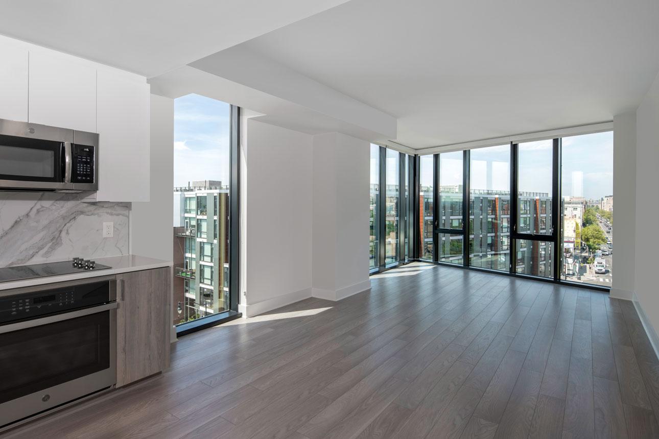 A kitchen in a Washington D.C. apartment, featuring a window and a door, providing natural light and access.