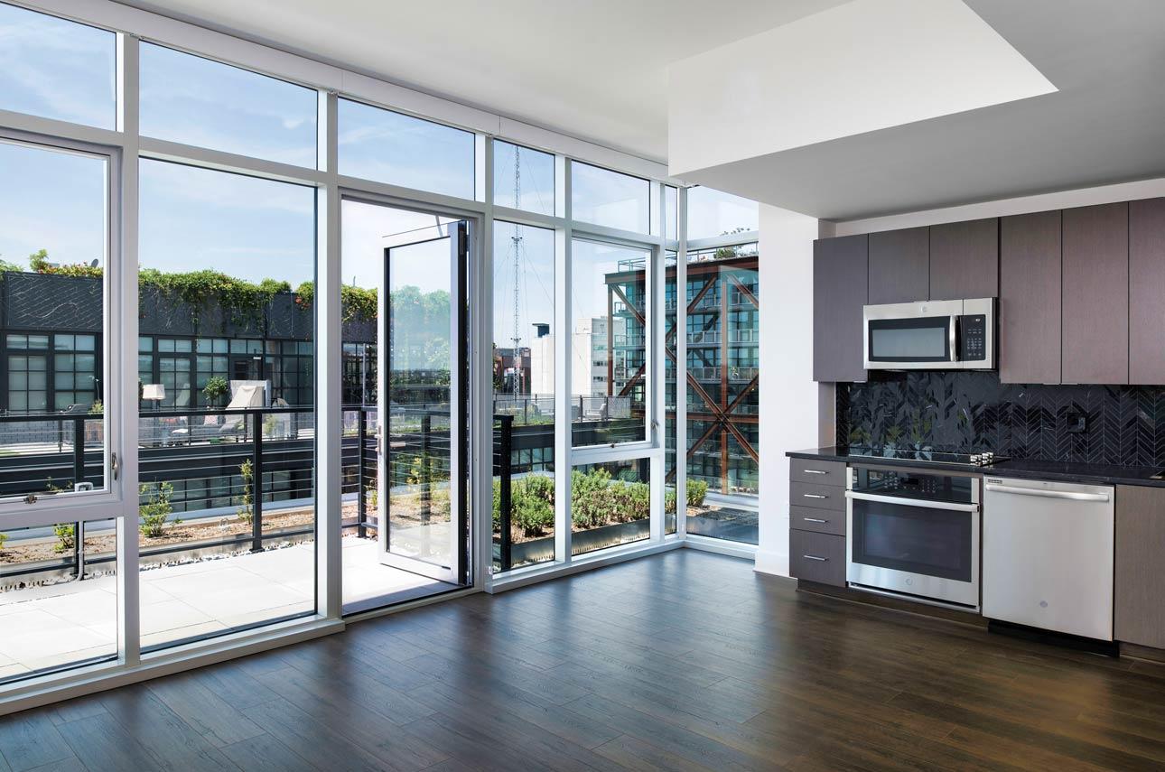 A kitchen in a Washington D.C. apartment, featuring a window and a door, providing natural light and access.