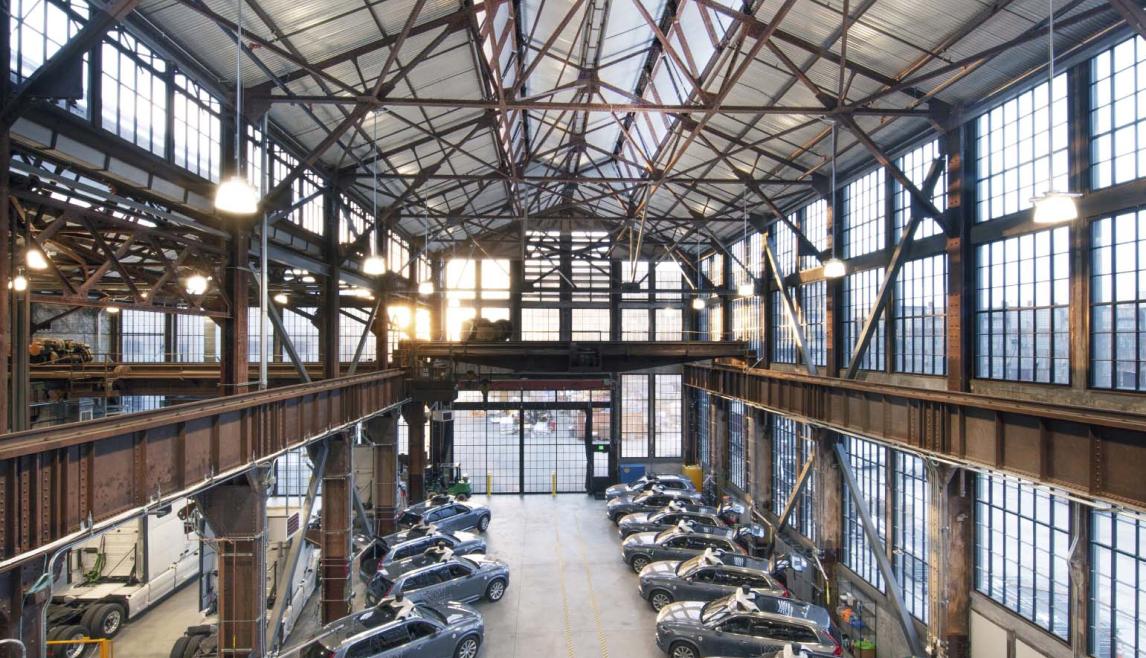 San Francisco’s Pier 70 Project Gets Historic Revamp with Winco’s Steel Replica Windows This large building holds vehicles inside. With a lot of exposed steel frames, the building also features large glass windows and hanging light fixtures.
