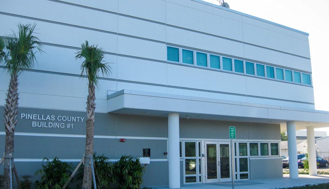 The Public Works Emergency Responders Building (PWERB) is a 2-story facility that is LEED Gold Certified and includes Winco tornado-rated windows. A tall commercial building with numerous windows against a clear blue sky. The architectural facade showcases a modern design, emphasizing the glass and structure of the property.