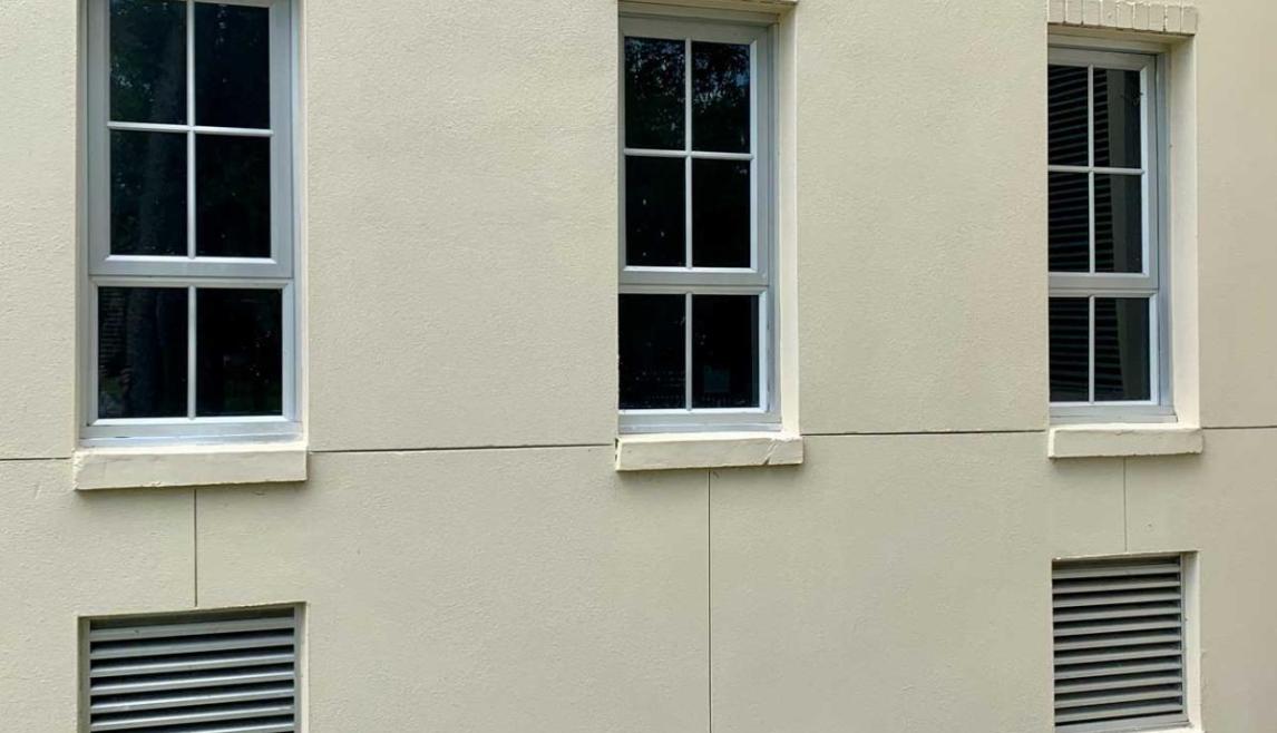 Winco's 1150S series windows fitted with hurricane laminated E-missile glass at the Louisiana Pump Station. Exterior of building with windows and trees in background