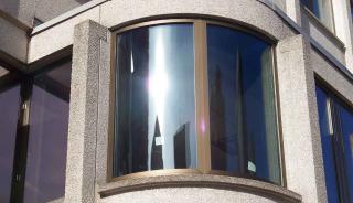 Close up of curved, blast resistant window on JFK building