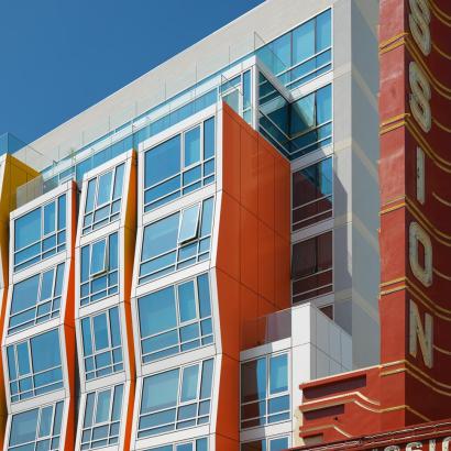 Large colorful facade of Vida Condos featuring multiple windows with zero sightline vents for ventilation and views of the streetscape.